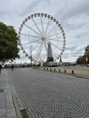 a large ferris wheel on a city street at Cosy duplex in center of Brussels in Brussels