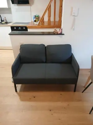 a black couch sitting in a living room at Cosy duplex in center of Brussels in Brussels