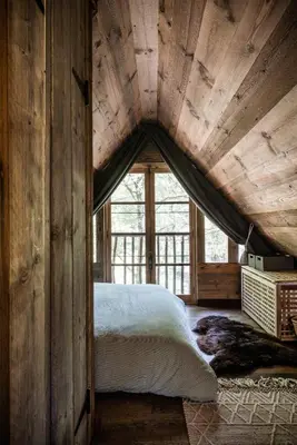 a bedroom with a bed and a large window at Tjiftjaf in Retie