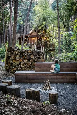 a girl sitting on a bench in front of a house at Tjiftjaf in Retie