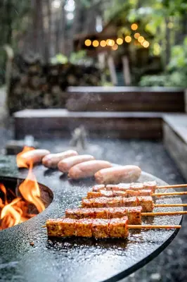 a grill with sausages and food on it with flames at Tjiftjaf in Retie