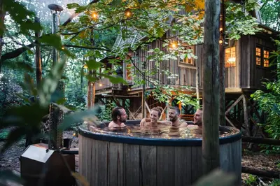 a group of people in a hot tub in a tree house at Buizerd in Retie