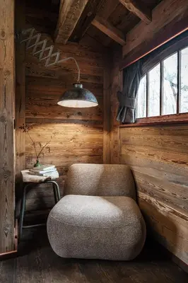 a room with a chair and a lamp and a table at Buizerd in Retie