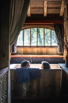 two women sitting in a bath tub in a house at Buizerd in Retie
