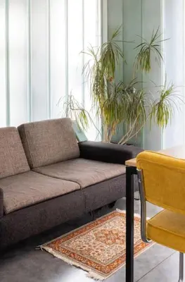 a living room with a couch and a table at Lightful architectural house in Ghent
