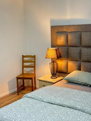 a bedroom with a bed and a lamp and a chair at Appartement n4 Bruxelles Centre Ville in Brussels