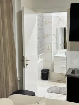 a white bathroom with a sink and a mirror at Appartement n4 Bruxelles Centre Ville in Brussels