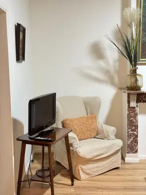 a living room with a couch and a computer on a table at Appartement n4 Bruxelles Centre Ville in Brussels