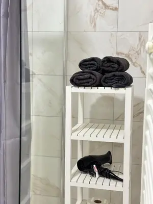 a white towel rack with towels on it in a bathroom at Appartement n4 Bruxelles Centre Ville in Brussels