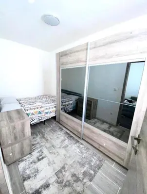 a bedroom with a bed and a large mirror at Appartement Bruxelles Belgique in Brussels