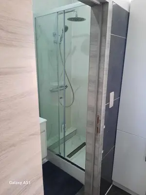 a shower with a glass door in a bathroom at Appartement Bruxelles Belgique in Brussels