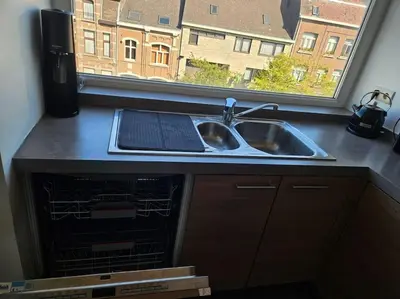 a kitchen counter with a sink and a window at Urban Comfort Mechelen in Mechelen