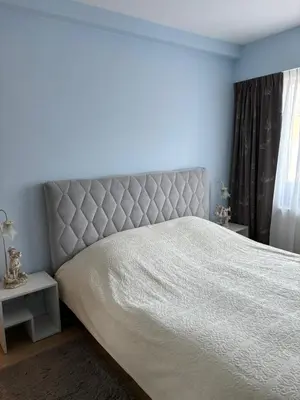 a bedroom with a large bed with a white bedspread at Urban Comfort Mechelen in Mechelen
