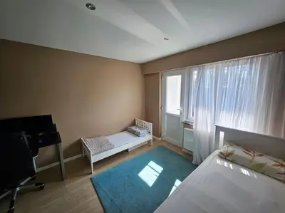 a room with a bedroom with a bed and a window at Urban Comfort Mechelen in Mechelen