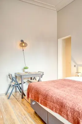 a bedroom with a bed and a desk with a lamp at Ghent's Historic Gem - Your Perfect Hideaway in Ghent
