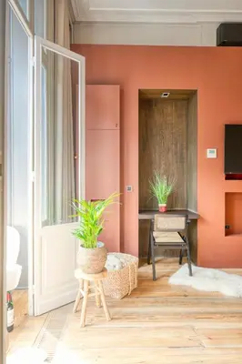 a room with orange walls and a table with two plants at Ghent's Historic Gem - Your Perfect Hideaway in Ghent