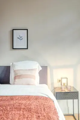 a bedroom with a bed and a table at Ghent's Historic Gem - Your Perfect Hideaway in Ghent