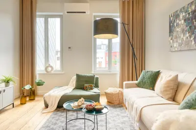 a living room with a couch and a table at Spacious & Luminous Gem in Historic Ghent Building in Ghent