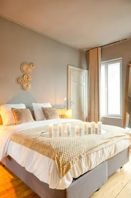 a bedroom with a large bed with candles on it at Spacious & Luminous Gem in Historic Ghent Building in Ghent