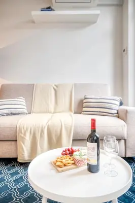 a bottle of wine on a table in a living room at Light-Filled Haven in Ghent in Ghent