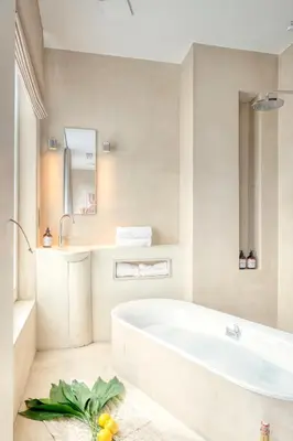 a white bathroom with a tub and a sink at Light-Filled Haven in Ghent in Ghent