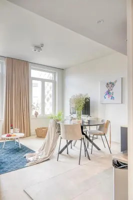 a living room with a table and chairs at Light-Filled Haven in Ghent in Ghent