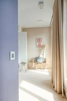 a living room with a chair and a table at Light-Filled Haven in Ghent in Ghent