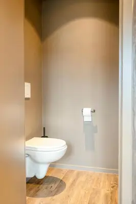 a bathroom with a white toilet in a room at Charming Attic Retreat in Historic Ghent Center in Ghent