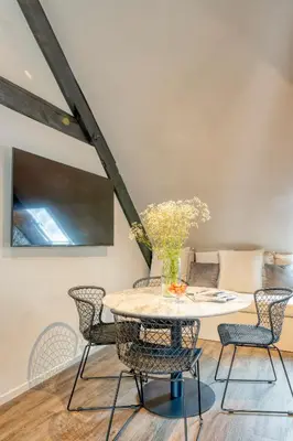 a dining room with a table and chairs at Charming Attic Retreat in Historic Ghent Center in Ghent