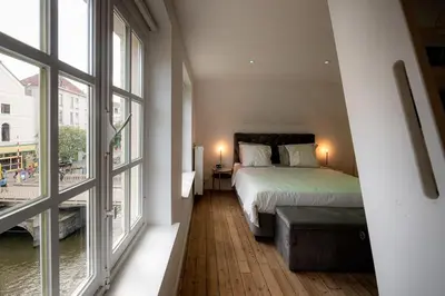 a bedroom with a bed and a large window at 8z dreamz in Ghent