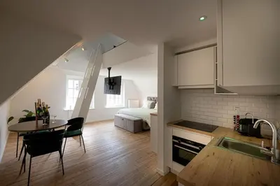 a kitchen and living room with a table and a bed at 8z dreamz in Ghent