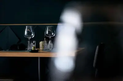 three wine glasses sitting on a wooden table at 8z dreamz in Ghent