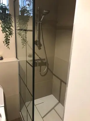 a shower in a bathroom with a glass door at Appartement lumineux - Bruxelles in Brussels