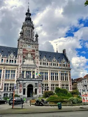 a large building with a clock tower on top of it at Appartement lumineux - Bruxelles in Brussels