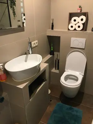 a bathroom with a white sink and a toilet at Appartement lumineux - Bruxelles in Brussels