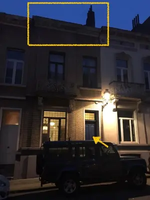 a black truck parked in front of a building at Appartement lumineux - Bruxelles in Brussels