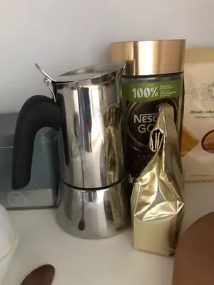 a coffee pot and a bag on a counter at Appartement lumineux - Bruxelles in Brussels