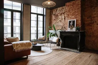 a living room with a brick wall and a fireplace at Boutique app in Antwerp Centre in Antwerp