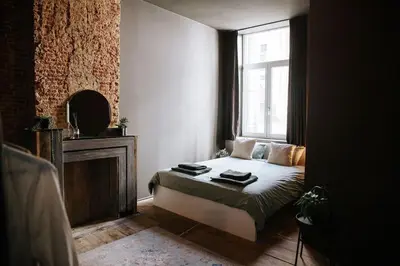 a small bedroom with a bed and a window at Boutique app in Antwerp Centre in Antwerp