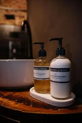 two bottles ofodorizers sitting on a counter next to a bowl at Boutique app in Antwerp Centre in Antwerp
