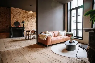 a living room with a couch and a fireplace at Boutique app in Antwerp Centre in Antwerp