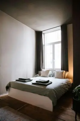 a bedroom with a large bed with a window at Boutique app in Antwerp Centre in Antwerp