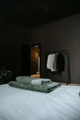 a bedroom with a bed and a mirror withothes at Boutique app in Antwerp Centre in Antwerp