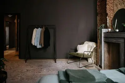 a bedroom with a mirror and a chair in a room at Boutique app in Antwerp Centre in Antwerp