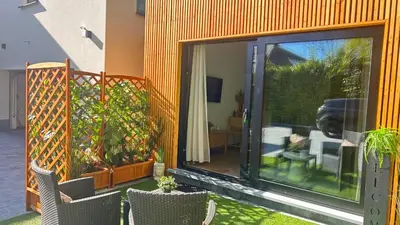 a sliding glass door of a house with a patio at MY Cabane -POOL HOUSE avec Sauna privée près de Bruxelles in Oppem