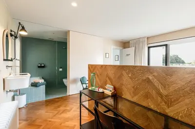 a bathroom with a wooden counter top in a room at Logieslogees in Tielrode