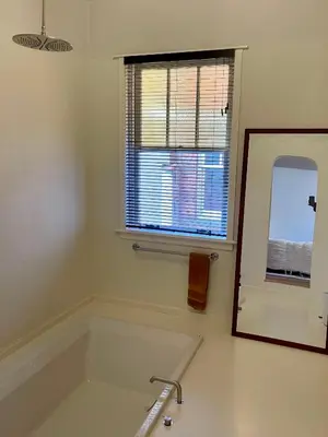 a white bathroom with a sink and a mirror at Huis Hector Mechiels HOUSE in Lindeken