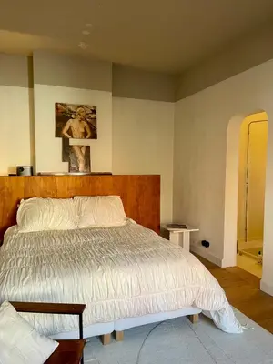 a bedroom with a bed and a painting on the wall at Huis Hector Mechiels HOUSE in Lindeken