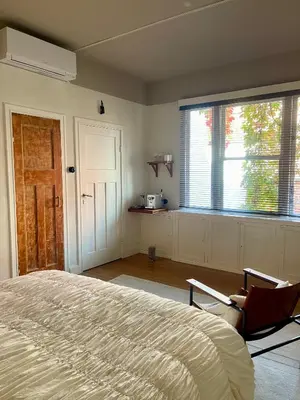 a bedroom with a bed and a large window at Huis Hector Mechiels HOUSE in Lindeken