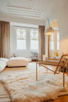 a living room with a table and a rug at Huis Hector Mechiels HOUSE in Lindeken